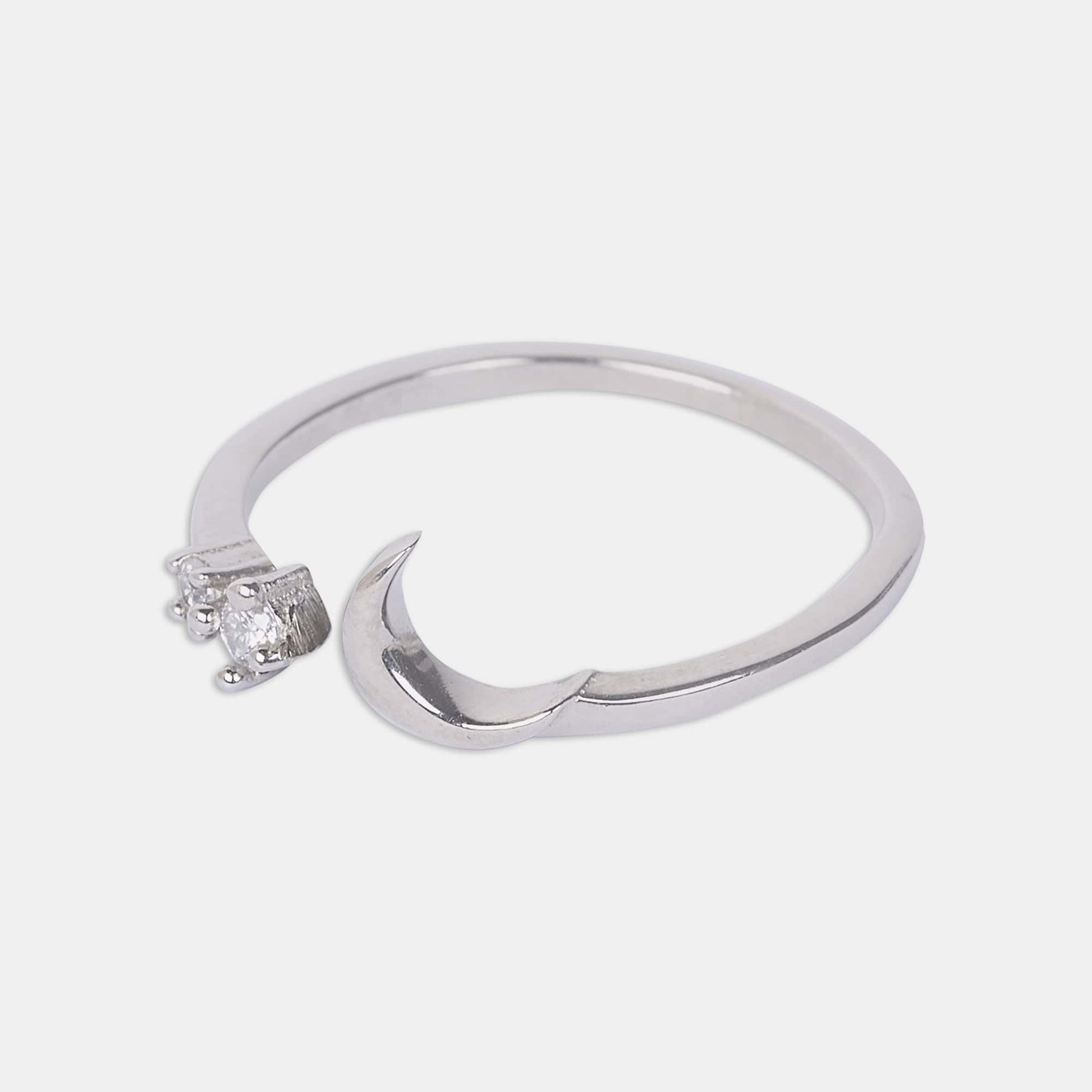 A sterling silver ring featuring a delicate crescent and star design