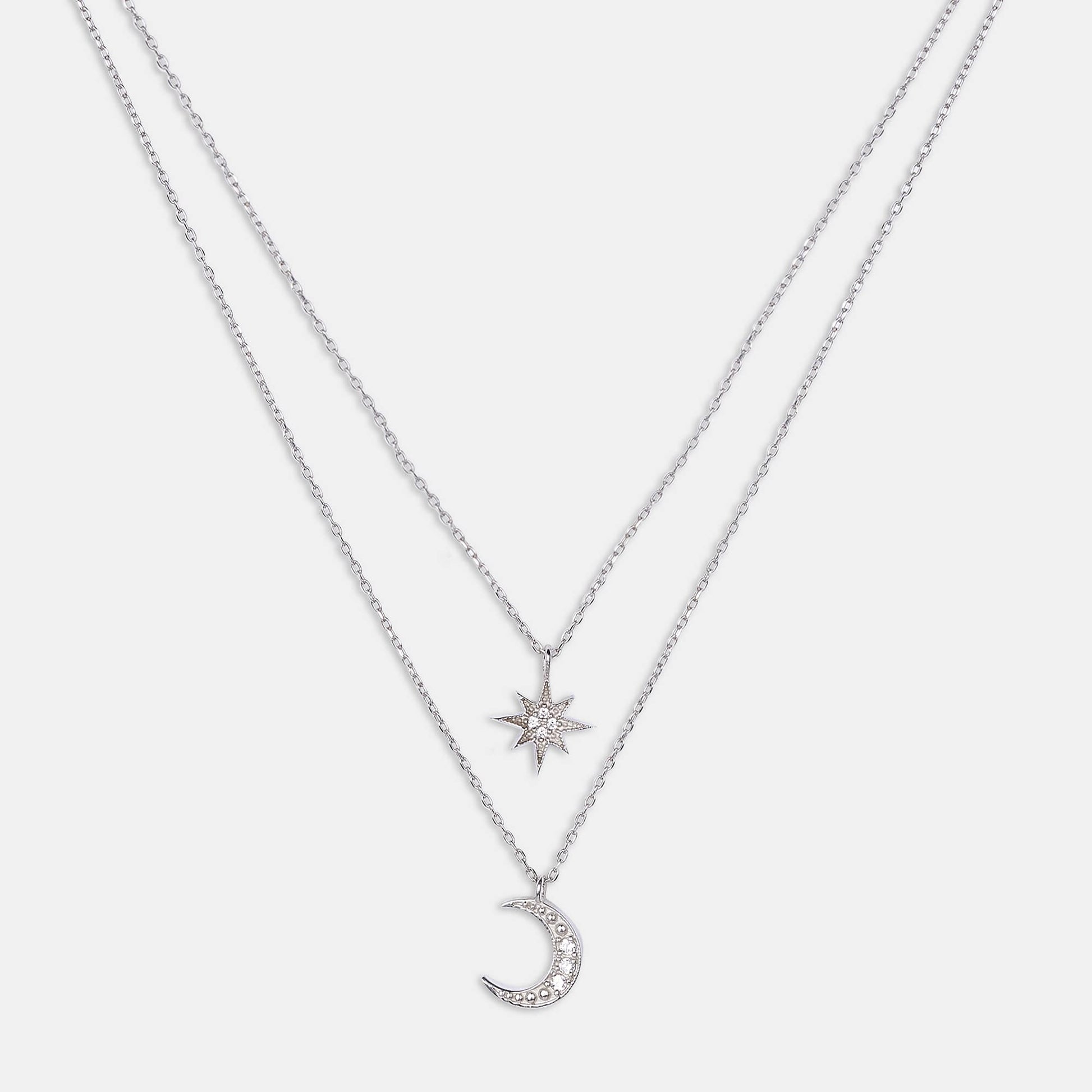 Discover our exquisite collection of sterling silver necklaces featuring a delicate moon pendant and a charming star pendant. Perfect for adding a touch of celestial elegance to any outfit.