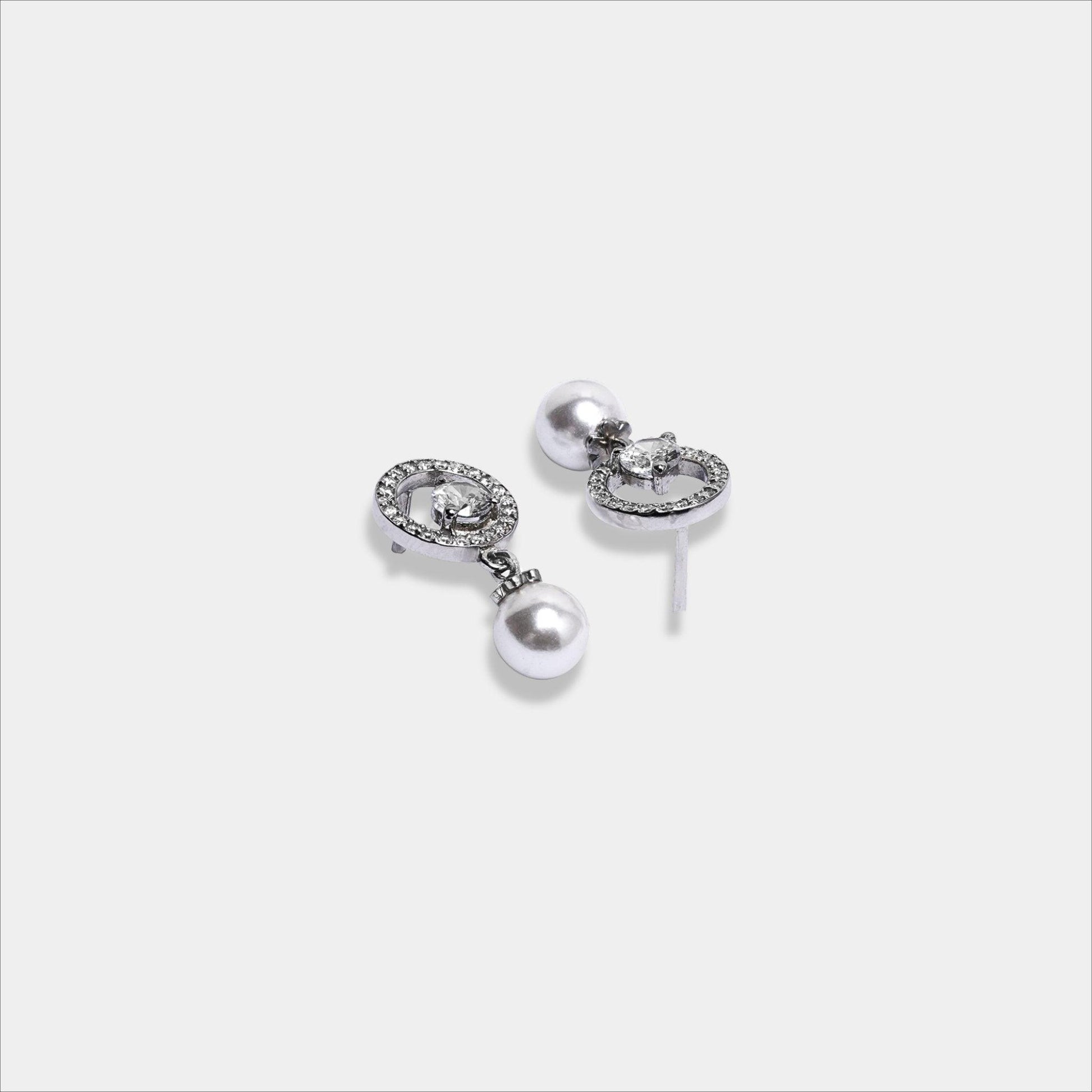  pair of dainty silver earrings featuring lustrous pearls.