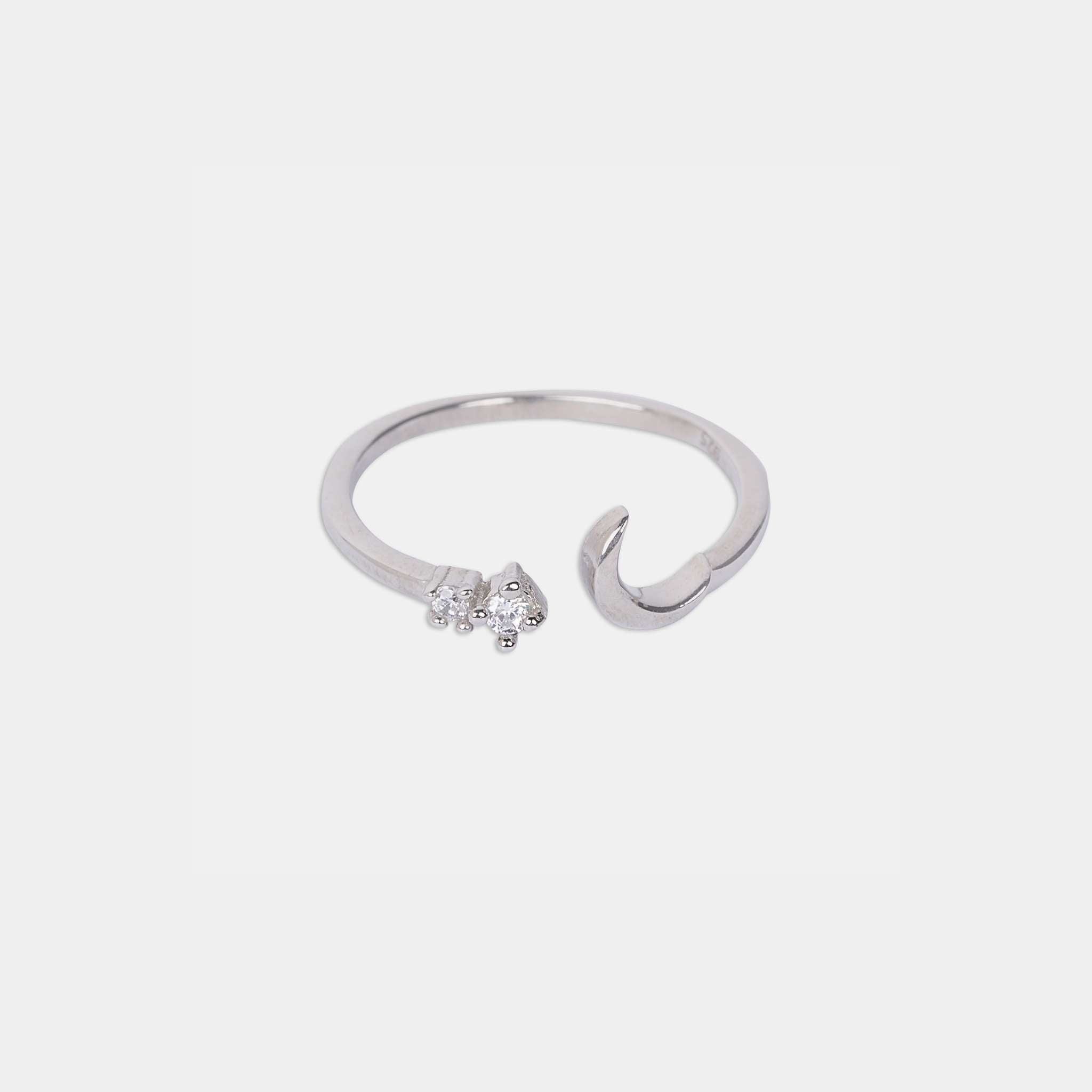 A sterling silver ring featuring a delicate crescent and star design