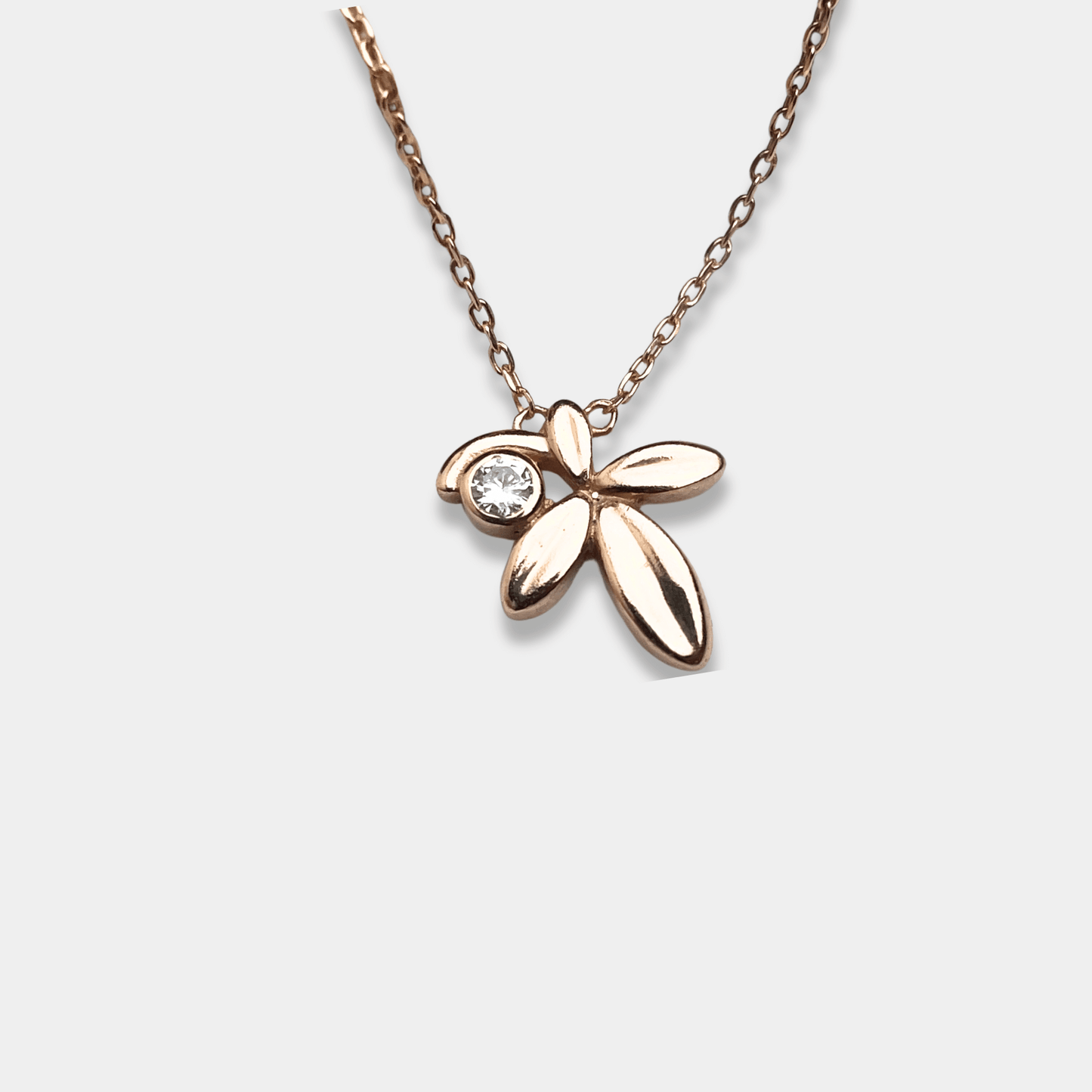A dainty silver necklace featuring a charming flower pendant. Perfect for adding a touch of elegance to any outfit.