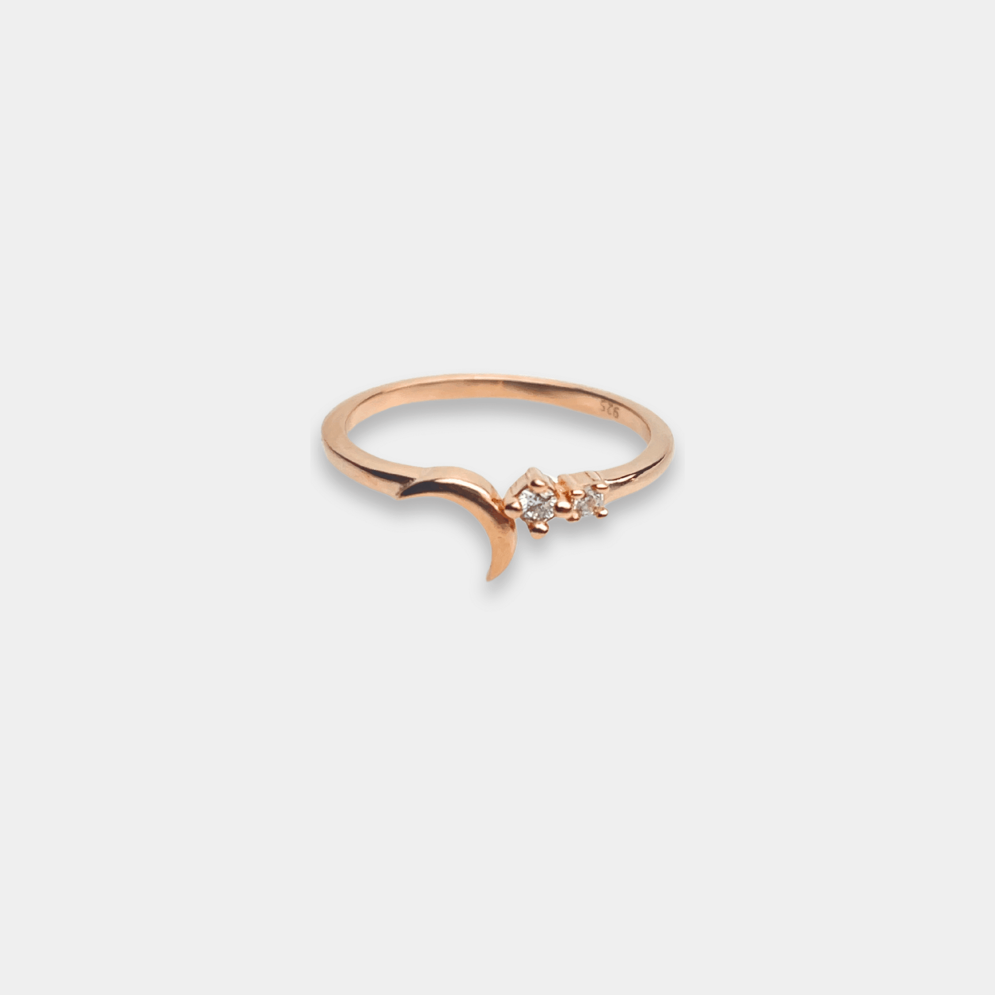 A stunning sterling silver ring with a crescent and star design, shining in beautiful rose gold.