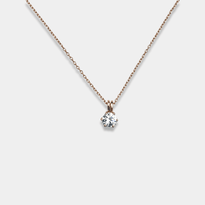 A sparkling diamond pendant elegantly hangs from a sterling silver chain, adding grace and beauty to your attire